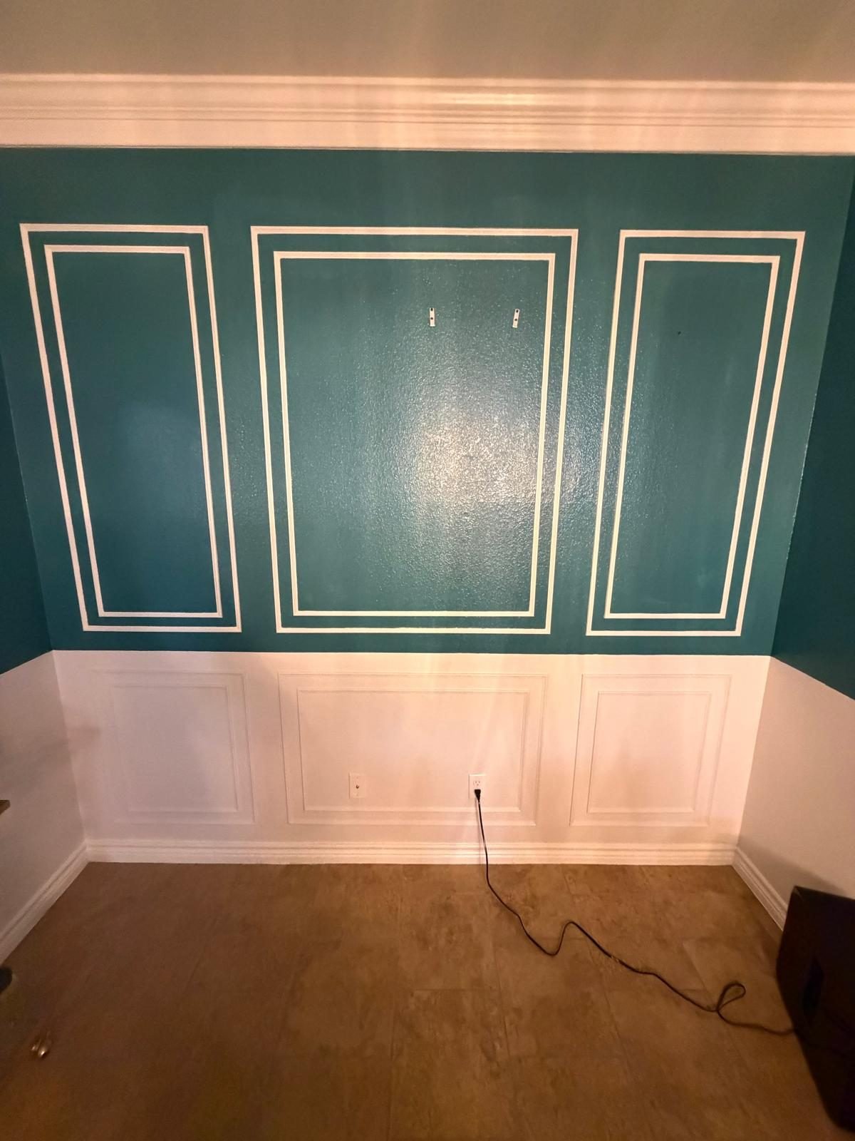 Teal wall with white panels