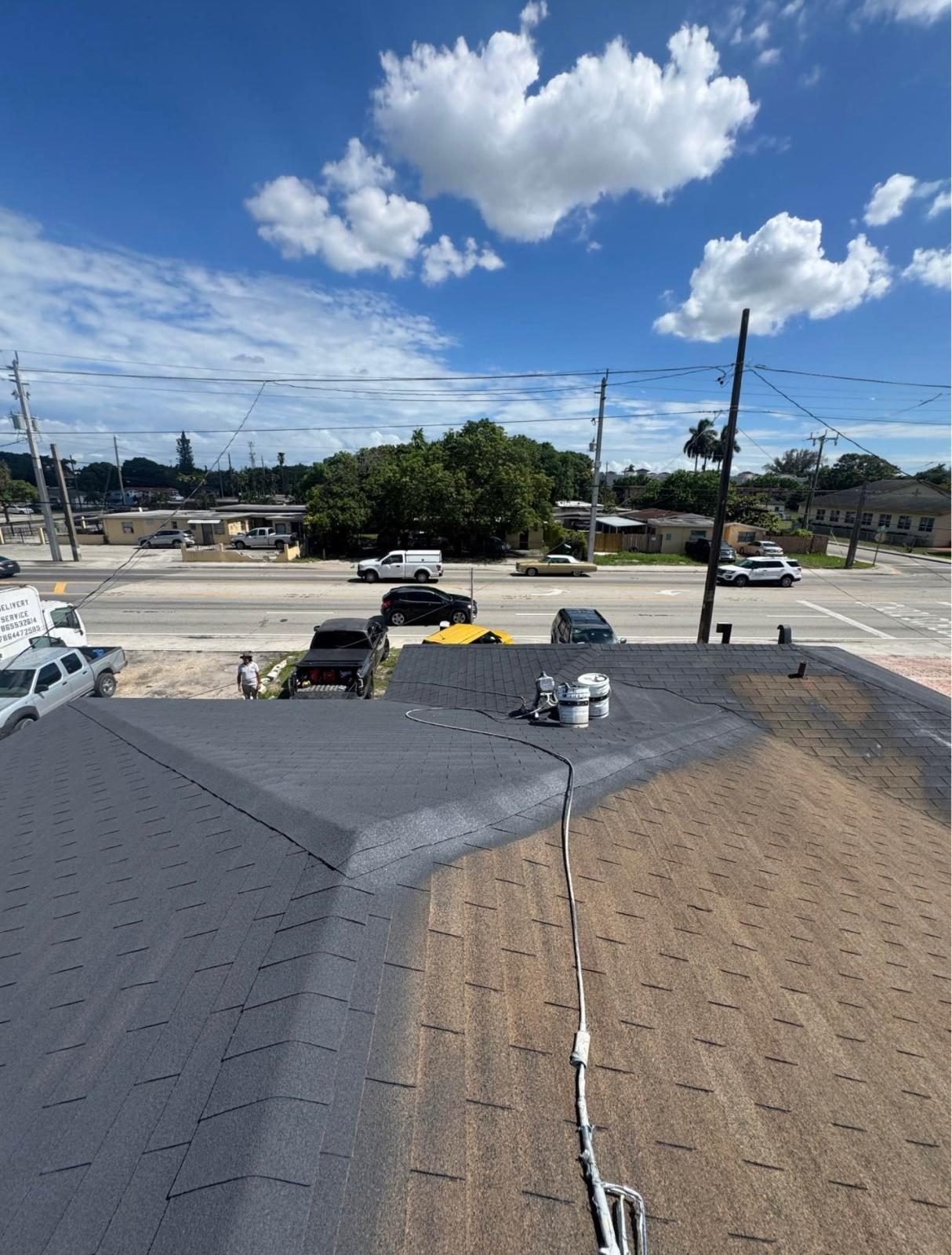 Shingle roof being pressure washed